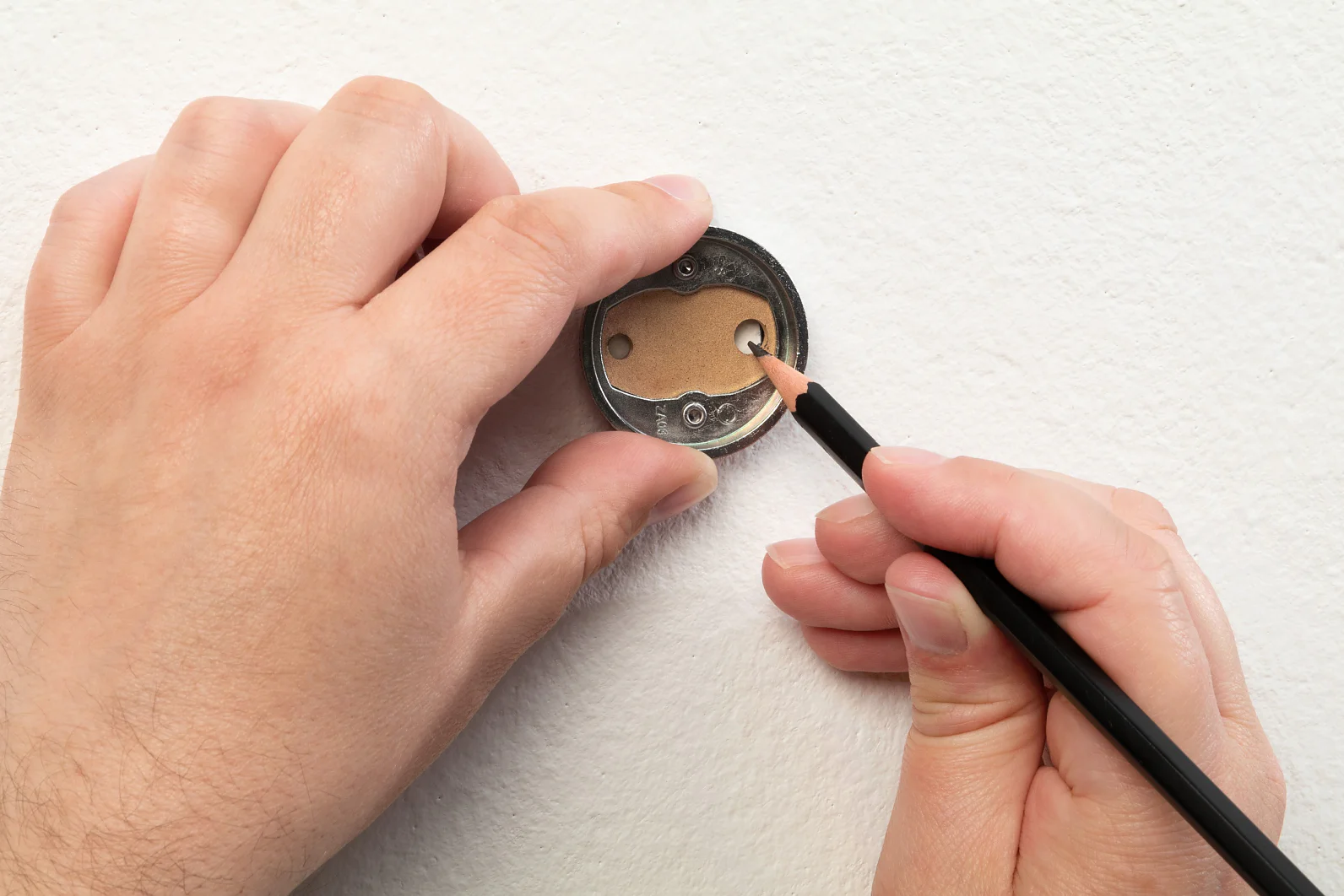 Markieren Sie die Bohrlöcher mit einem Stift. Nutzen Sie hierbei den Adapter als Schablone.