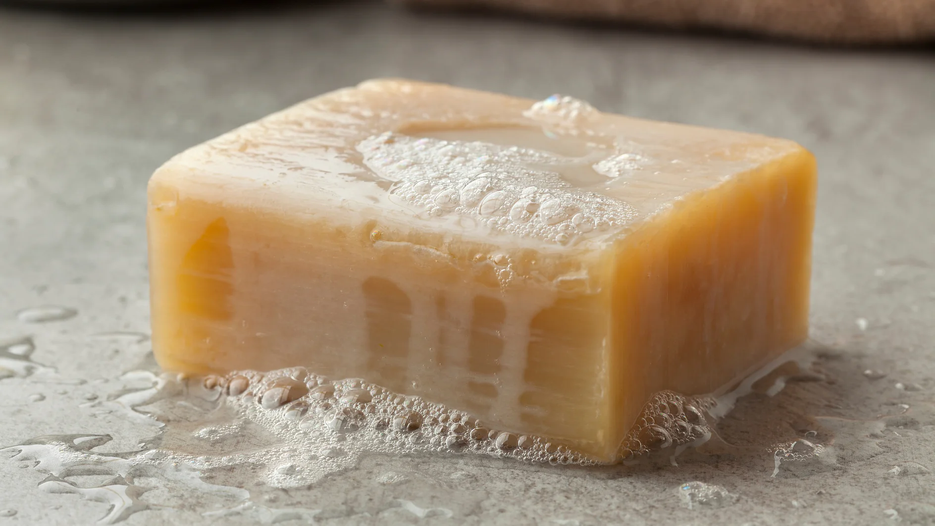 Wet piece of traditional Moroccan soap with foam for hamam