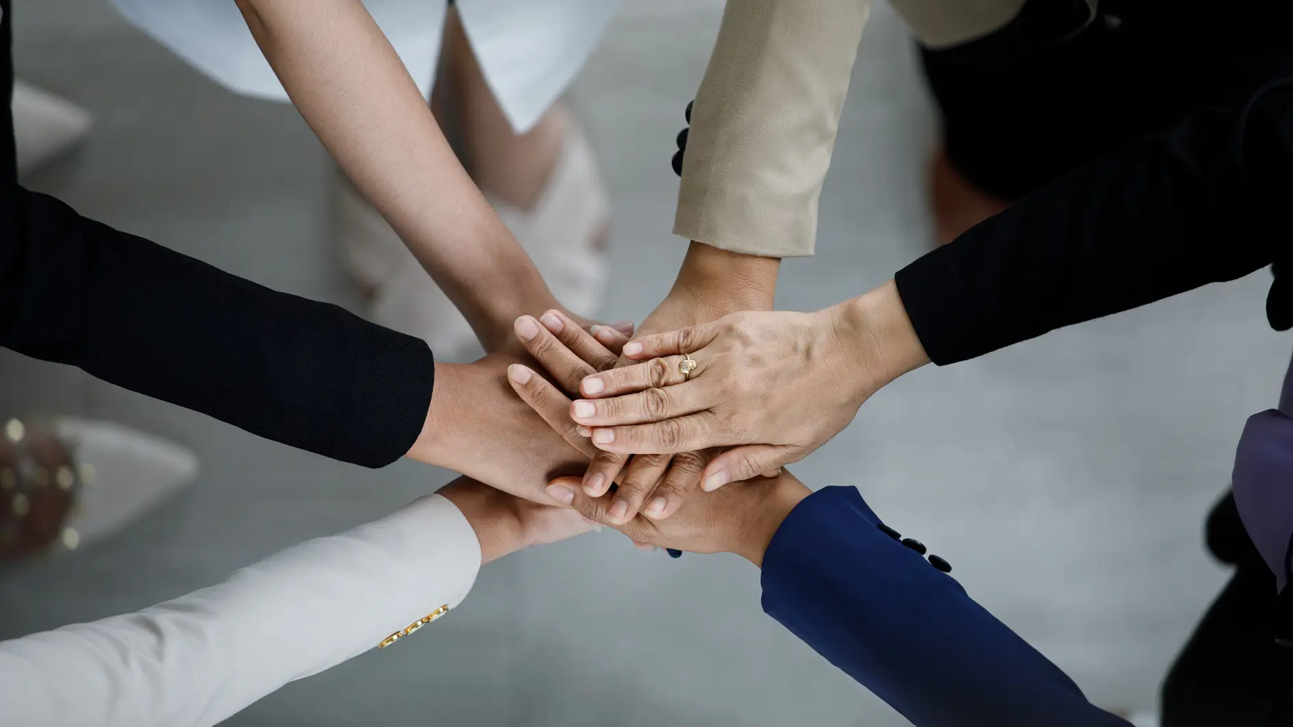 Top view close up shot of professional successful group of businessman businesswoman colleagues partnership team hands holding together for company strong trust teamwork unity achievement commitment.